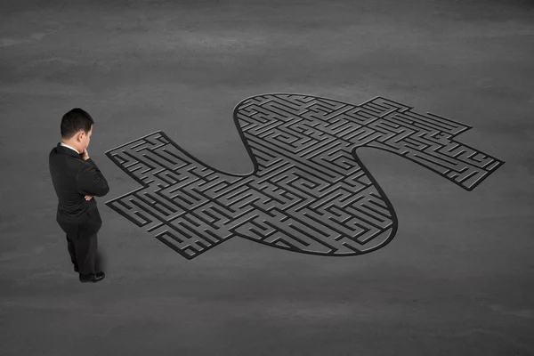 Businessman facing money symbol maze — Stock Photo, Image