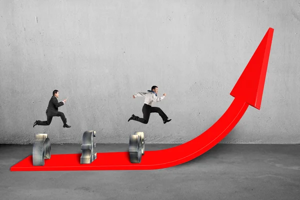 Businessmen competing on growing red arrow — Stock Photo, Image