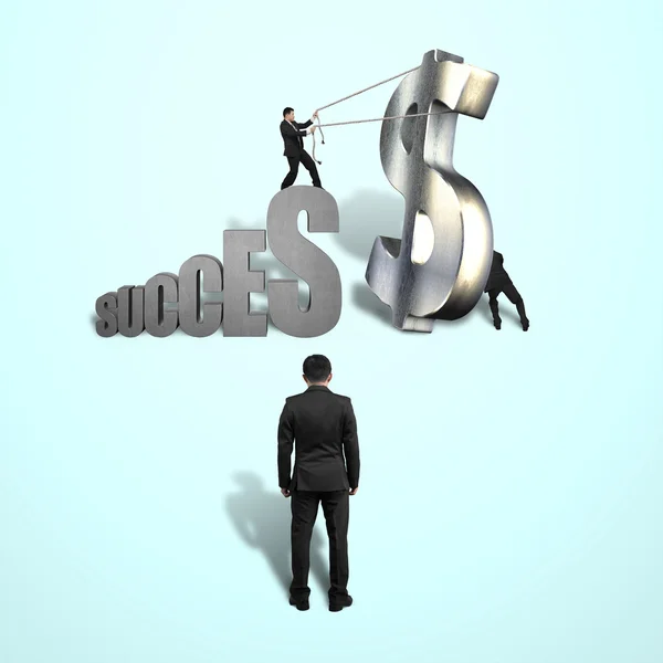 Trying to stand large money symbol for success — Stock Photo, Image