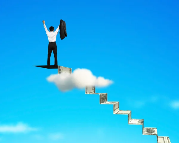 Man cheering on top of money stairs — Stock Photo, Image