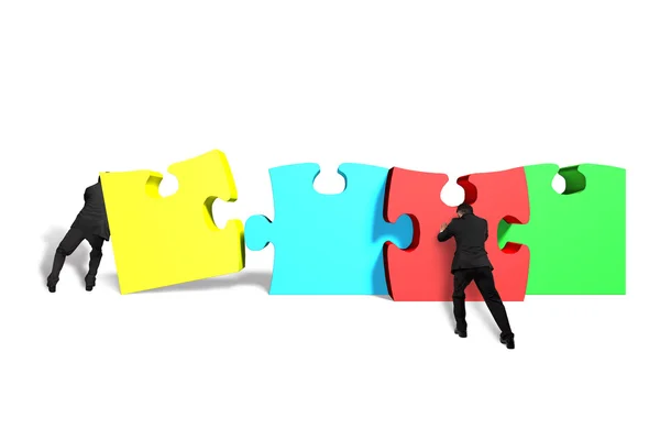 Men assembling puzzles — Stock Photo, Image