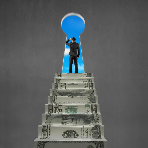 Man looking on top of money stairs with key hole — Stock Photo, Image