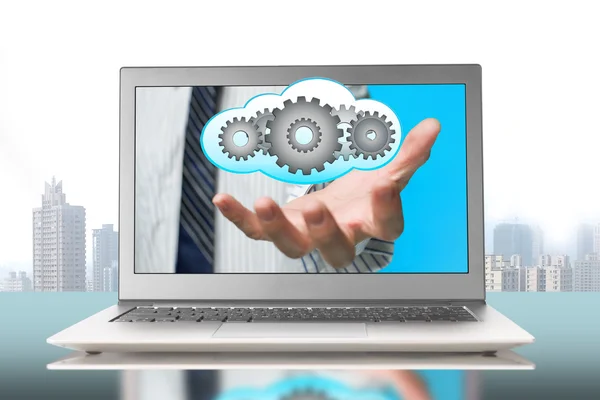 Hand out front screen with gears inside cloud — Stock Photo, Image