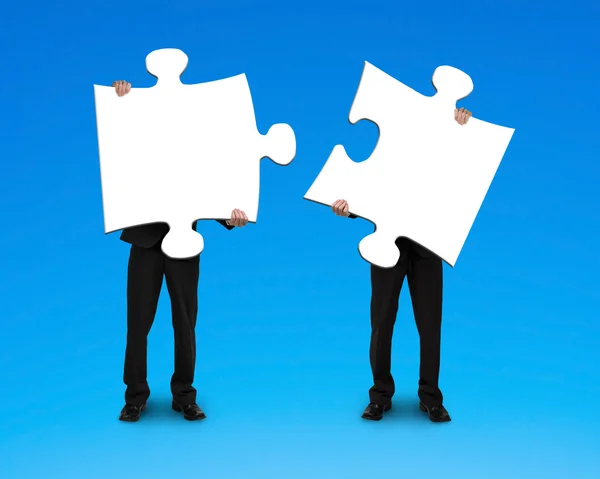 Two businessmen assembling puzzles — Stock Photo, Image