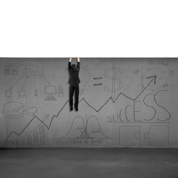 Man trying to climb over wall with business doodles — Stock Photo, Image