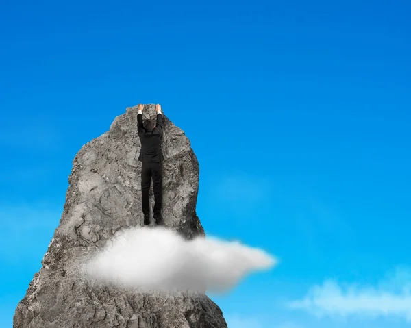 Businessman climbing to top of rock mountain — Stock Photo, Image