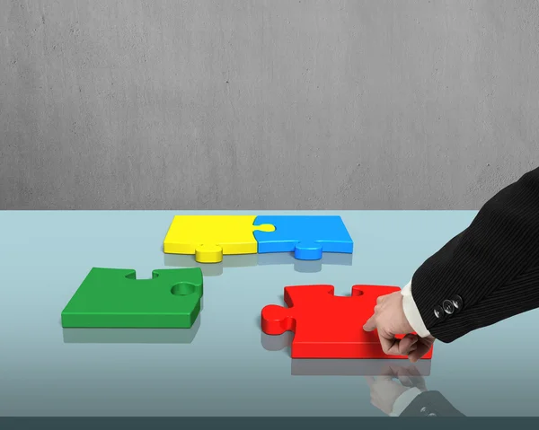 Assembling puzzles on table — Stock Photo, Image