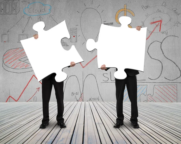 Two people holding puzzles to connect — Stock Photo, Image