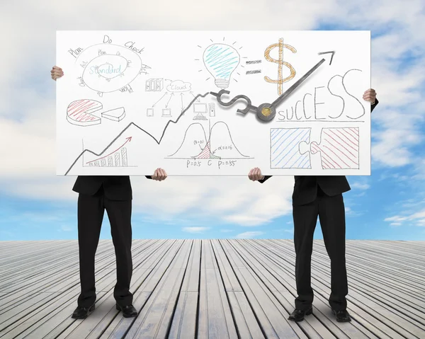 Two men lifting billboard with clock hands and doodles — Stock Photo, Image