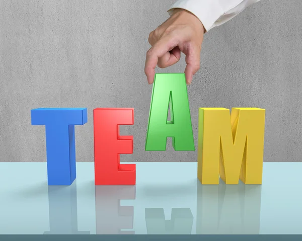 Put TEAM together on glass table — Stock Photo, Image