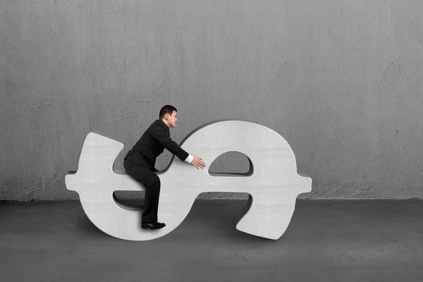 Riding on concrete money symbol — Stock Photo, Image