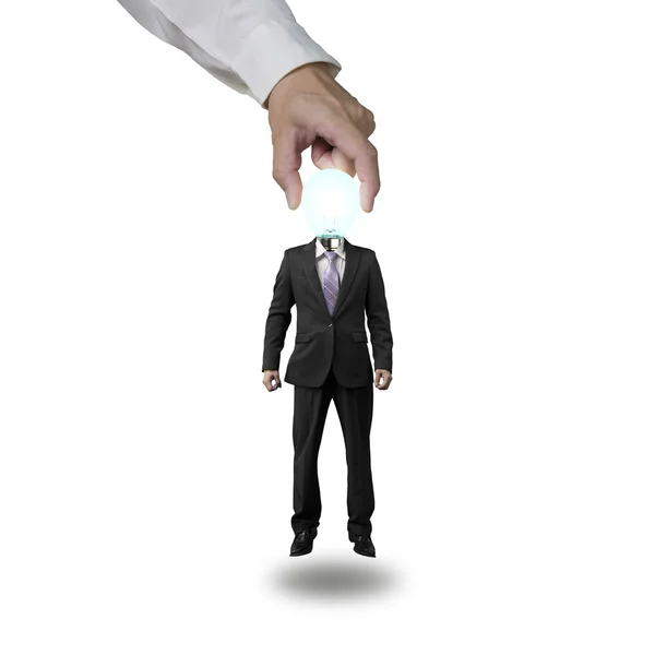 Hand picking up glowing lamp head businessman — Stock Photo, Image