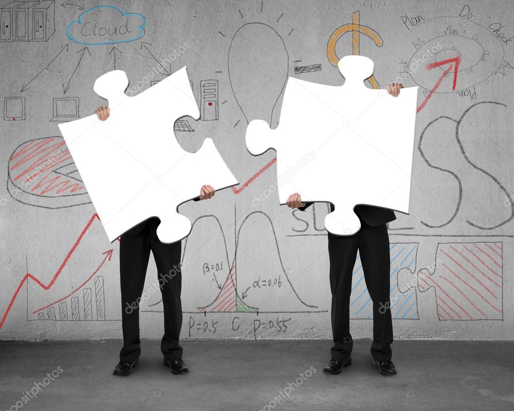 Two men assembling puzzles with business doodles background