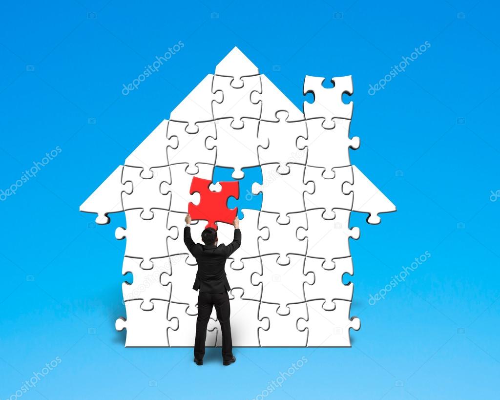 Assembling last red puzzle into house shape