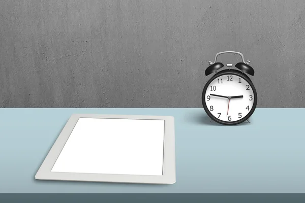 Tablet and alarm clock on table — Stock Photo, Image