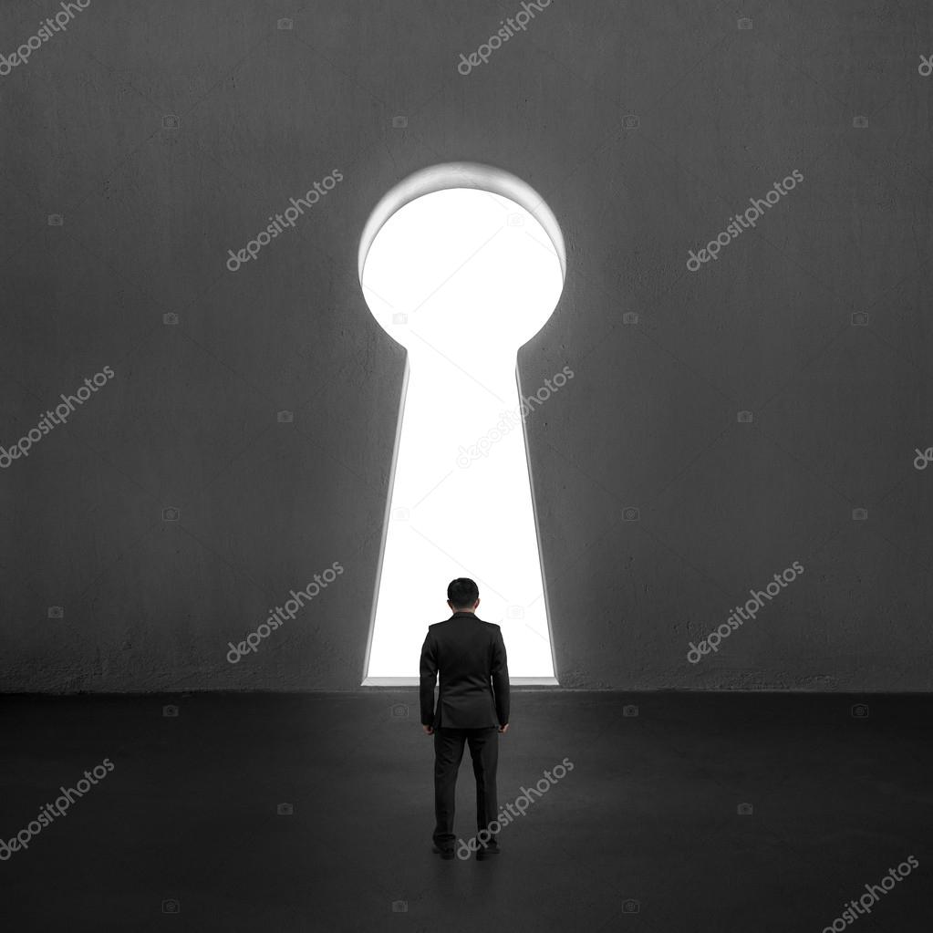 Businessman standing toward key shape door — Stock Photo © bruesw #47785091
