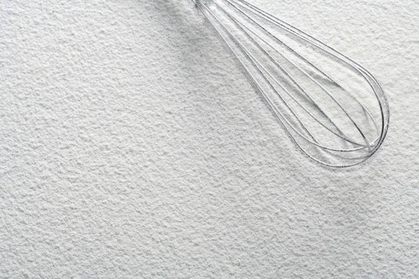 Wire whisk on flour — Stock Photo, Image