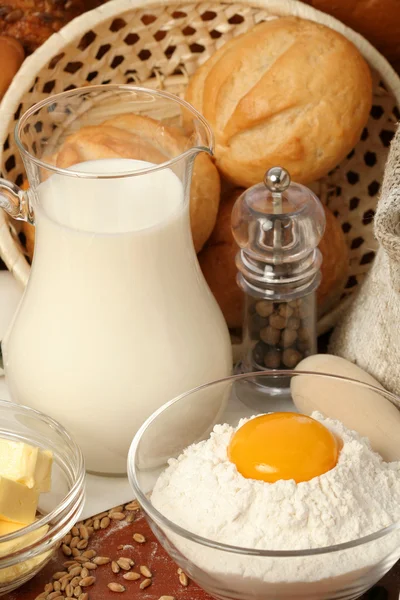 Jug of milk, butter and flour with yolk — Stock Photo, Image