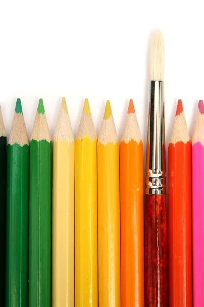 Colour wooden pencils around of an art brush — Stock Photo, Image