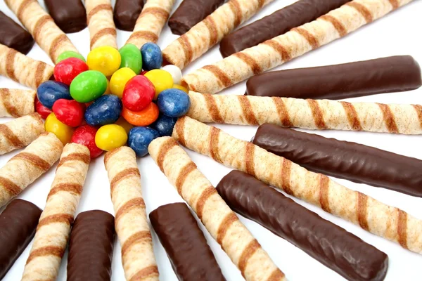 Chocolate sticks with a cream and the multi-coloured sweets isol — Stock Photo, Image