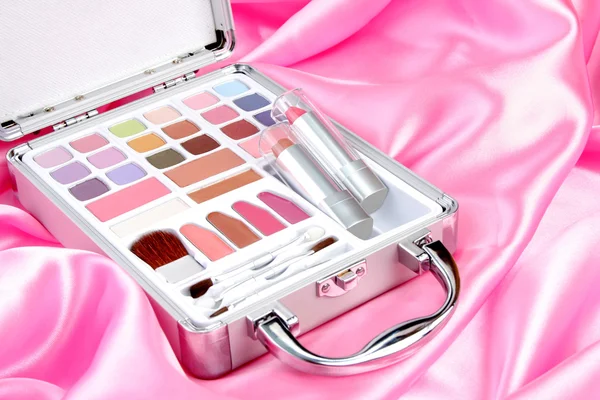 Makeup briefcase on pink satin — Stock Photo, Image