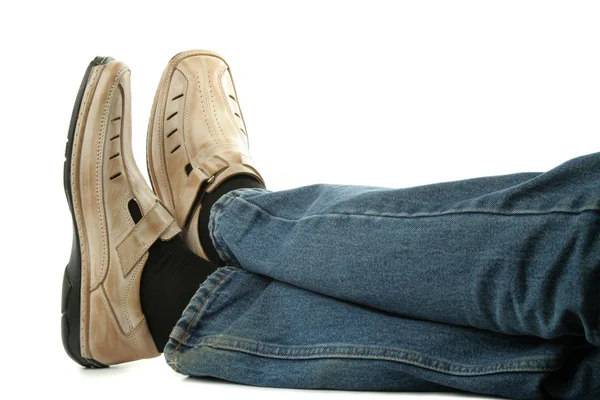 Human foot with brown leather shoes and jeans — Stock Photo, Image