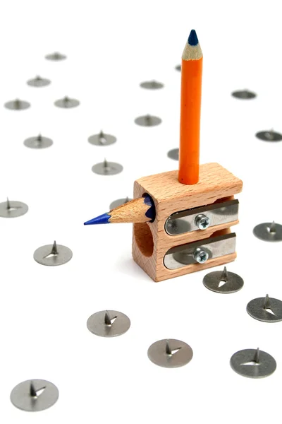 The small pencil is saved from danger on a universal sharpener — Stock Photo, Image