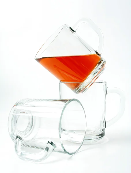 Three glass mugs and black tea — Stock Photo, Image