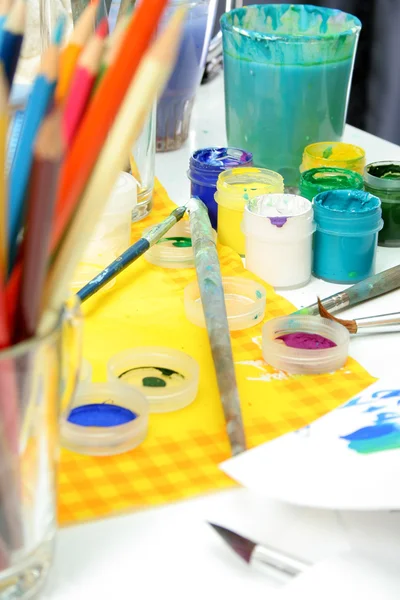 Tools of the artist: paints, brush, pencils and a paper — Stock Photo, Image