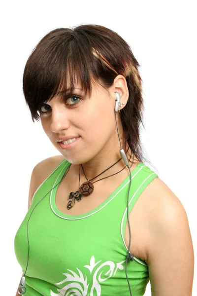 Uma menina sorridente com fones de ouvido de celular — Fotografia de Stock