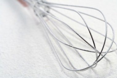 Wire whisk on flour