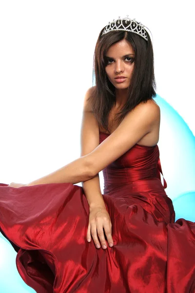 Girl in an red evening dress and with a diadem — Stock Photo, Image