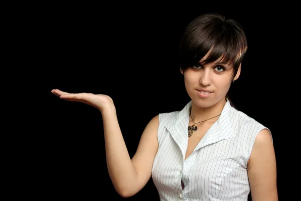 Het jonge meisje houdt iets in een hand — Stockfoto