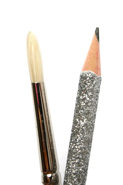 Art brush near to a celebratory brilliant pencil for plotting — Stock Photo, Image
