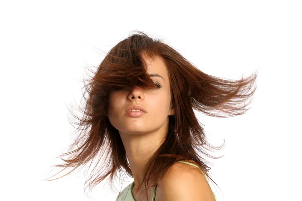 Young brunette girl with a hairdress in movement — Stock Photo, Image