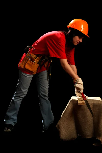 Young woman with work tools and hand saw — Stock Photo, Image