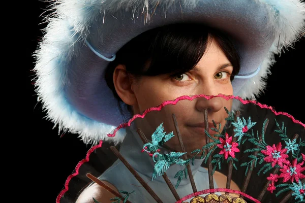 Brunette girl with cowboy hat and spanish fan — Stock Photo, Image