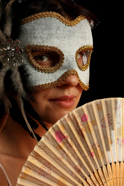 Young brunette with venetian mask and spanish fan — Stock Photo, Image