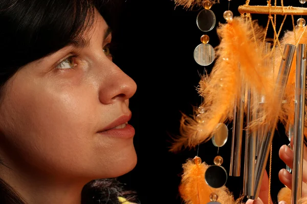 Young brunette and wind chime — Stock Photo, Image