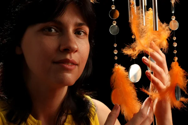 Young brunette and wind chime — Stock Photo, Image