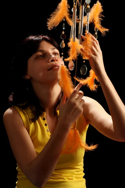 Young brunette and wind chime — Stock Photo, Image