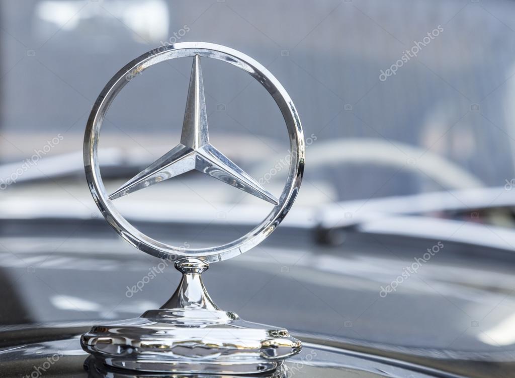 Stuttgart,Germany- August 11,2013: Mercedes logo on a traditional car in front of an ellegant hotel in Stuttgart,Germany.In Stuttgart is the headquarter of Mercedens-Benz.