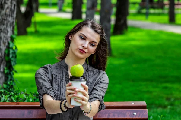 Young Woman Studying Park Holds Green Apple Cup Coffee Looking —  Fotos de Stock