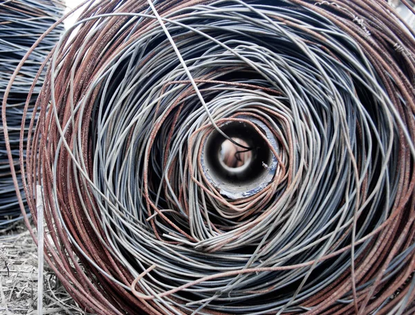 Wire reeled up on a pipe — Stock Photo, Image