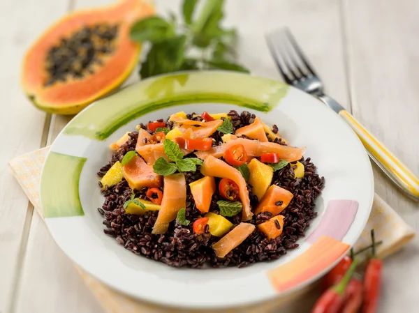 Zwarte rijst met papaja en gerookte zalm, selectieve focus — Stockfoto