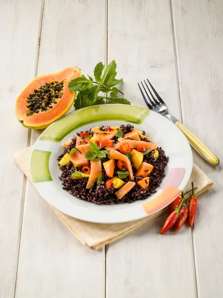 Черный рис с папайей и копченым лососином — стоковое фото