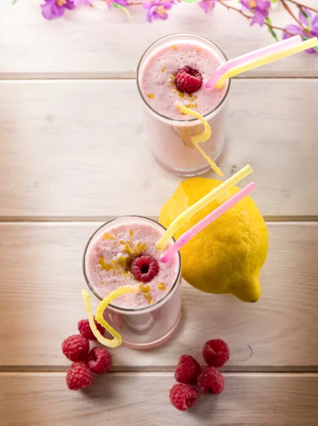 Raspberry milkshake on glass with straw — Stock Photo, Image