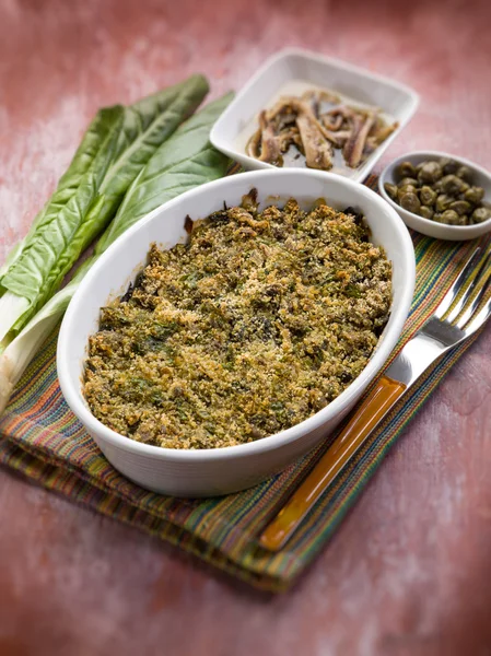 Gratin of swiss chard anchovies and capers, selective focus — Stock Photo, Image