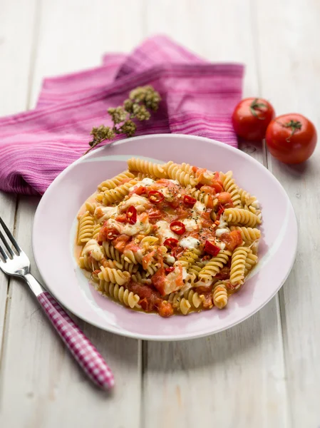 Fusilli with mozzarella tomatoes and hot chili pepper, selective — Stock Photo, Image
