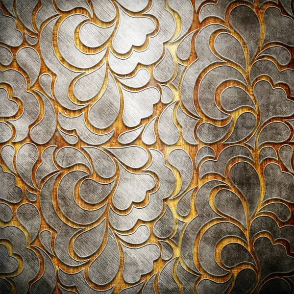 Металлический орнамент на старом деревянном фоне — стоковое фото
